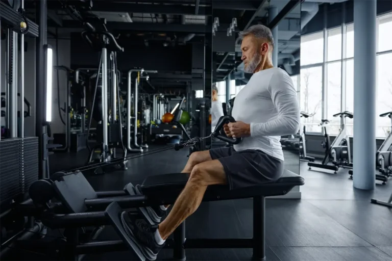 Senior man performing cable row exercise with exercise physiologist Melbourne guidance demonstrating health and fitness progressions for older adults