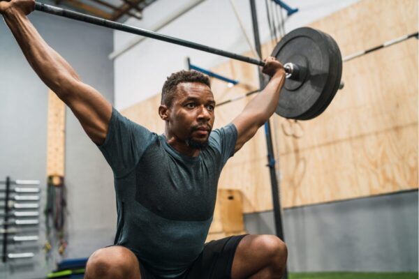 Strength and conditioning Melbourne athlete training with exercise physiologist supervision during Olympic lifting session